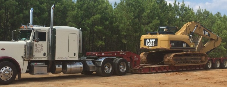 hydraulic excavator on top of flat bed